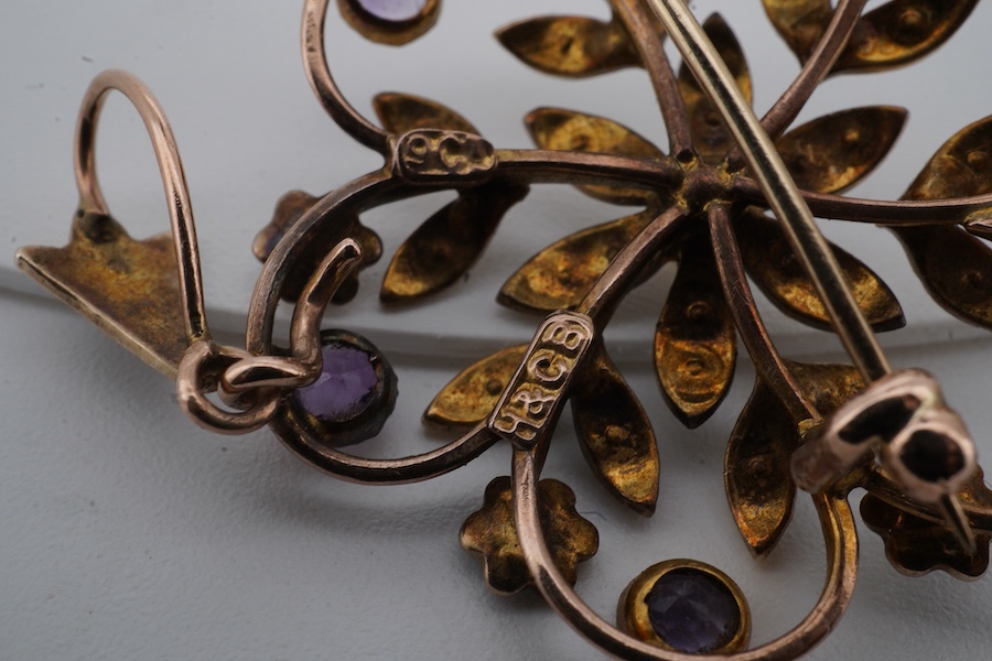 An Edwardian seed pearl and amethyst pendant, early 20th century, of floral design, set with seed pearls and circular-cut amethysts, mounted in gold, length 4cm including bail, brooch fitting, stamped 9ct and H&GB, Condi
